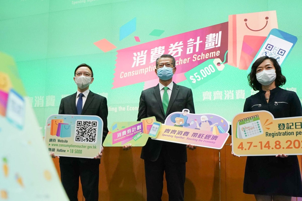 Hong Kong Financial Secretary, Paul Chan (midde), and other government officials held a press conference Friday to announce details of the city’s cash voucher scheme. (Photo: SCMP / Felix Wong)