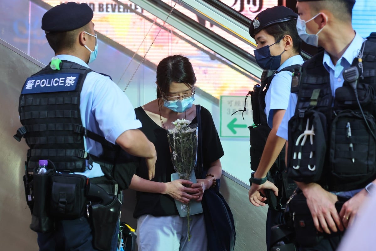Some people stopped at Sogo department store in Causeway Bay to lay flowers in memory of the attacker, surnamed Leung, who killed himself after stabbing a police officer on July 1, 2021. Photo: SCMP/Dickson Lee