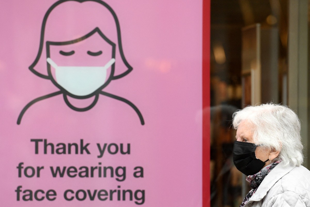 A sign encouraging people to wear a mask in Britain. Coronavirus cases worldwide have been surging, especially among the unvaccinated. Photo: AFP