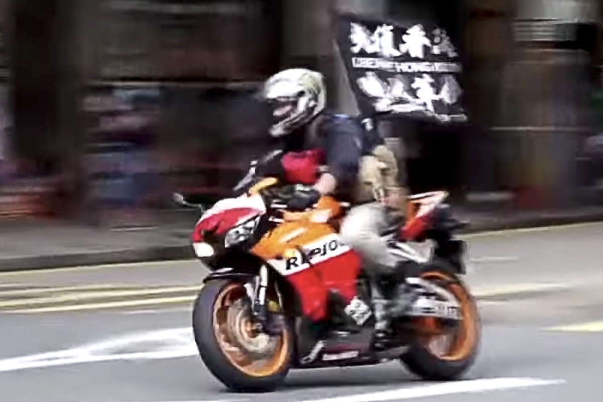 Leon Tong was accused of ramming his motorcycle into three police officers while flying a banner calling for Hong Kong’s ‘liberation’. Photo: Cable TV