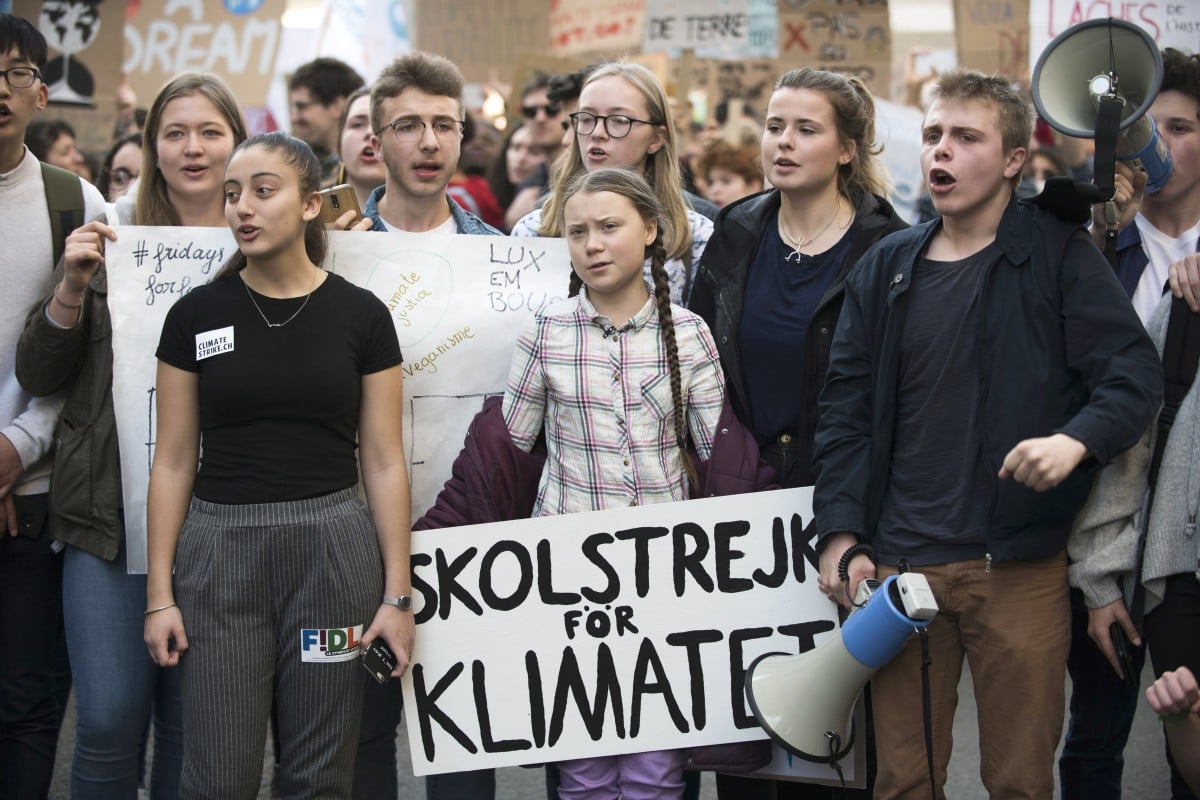 Swedish climate activist Greta Thunberg (C), 16, and French students gather to call for urgent measures to combat climate change during a demonstration in Paris.