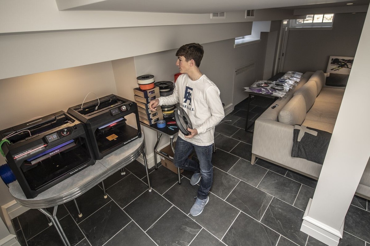 Louie Beardell, who uses 3D printers to make face shields to donate to area medical workers, at his home's basement.