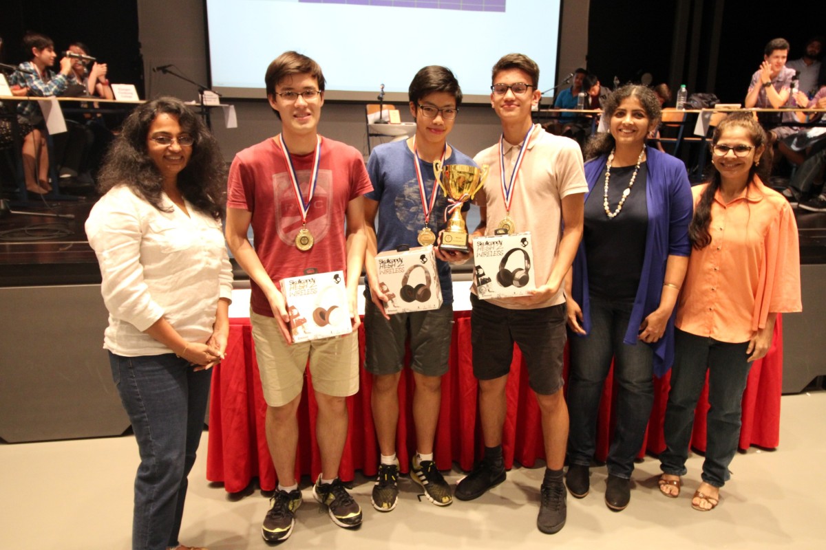 Champion Island School winners (boys from left to right) Matthew Wright, Justin Mak and Zaheu Jacota pose with event organisers.
