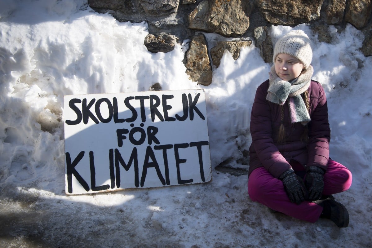 Teen climate activist Greta Thunberg participates in the 'School Strike for Climate', as written in Swedish on her placard, in Davos at the WEF.