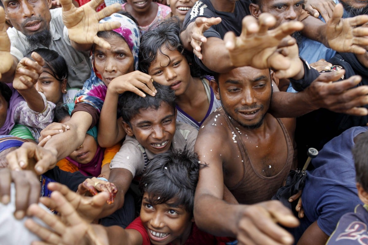 Rohingya refugees from Myanmar's Rakhine state wait for aid at Kutupalong refugee camp in the Bangladeshi town of Teknaf.
