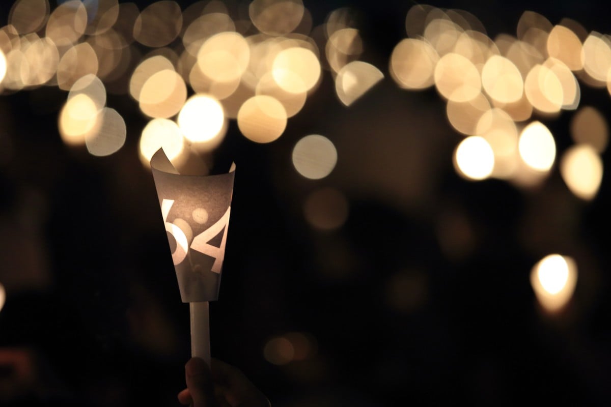 Against the night, candles shine in remembrance of those who lost their lives on June 4, 1989.