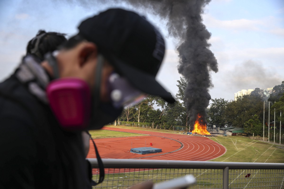 A fire rages on a sports field at the campus of Chinese University.