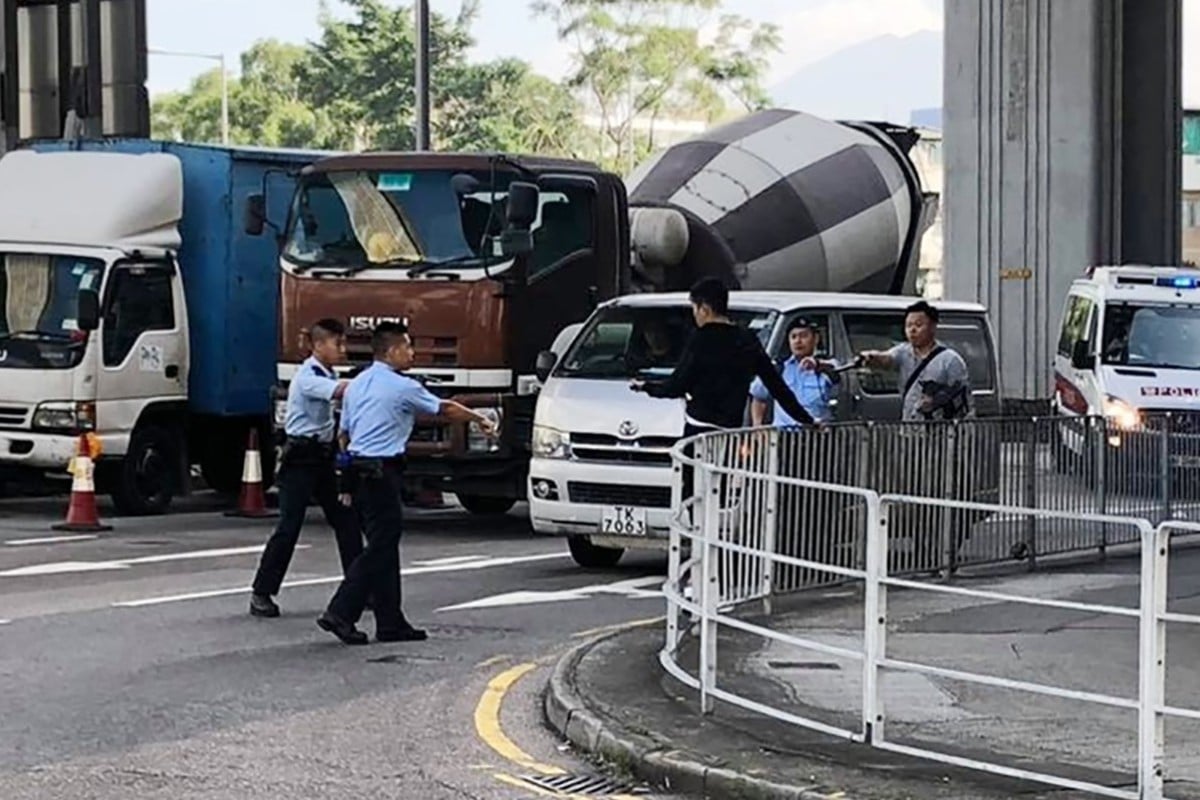 Officers trying to subdue a man in Yuen Long after a gang fight.