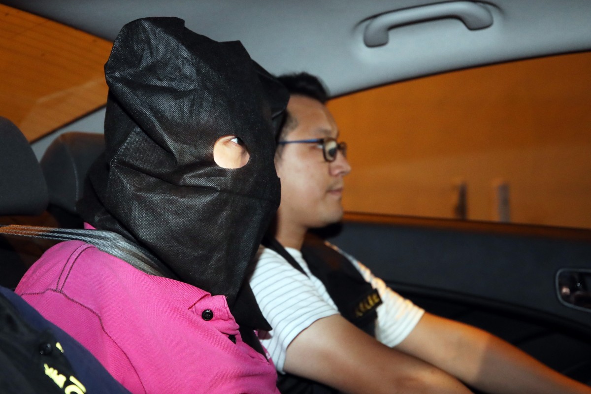 A suspect arrested in connection with the Yuen Long violence on Sunday night is escorted to Tin Shui Wai police station.