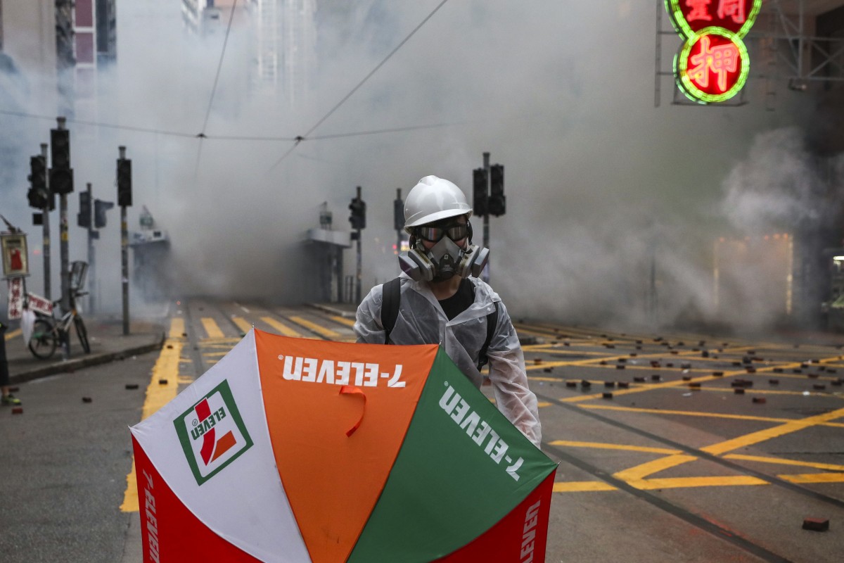 Clouds of tear gas have little effect on an anti-government protester in Wan Chai.