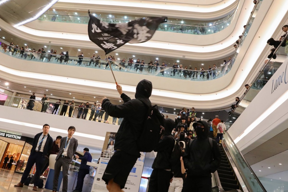 Scores of people dressed in black, chanting slogans including "disband police now" and "Hong Kong independence" gathered at Times Square mall in Causeway Bay on Christmas Day.