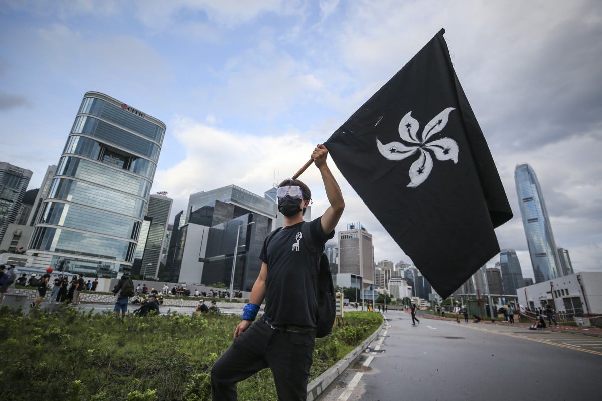 Protesters carrying umbrellas march against the extradition bill outside the Legislative Council Complex in Tamar on the 22nd anniversary of Hong Kong's handover from Britain to China. 01JUL19 SCMP / Winson Wong