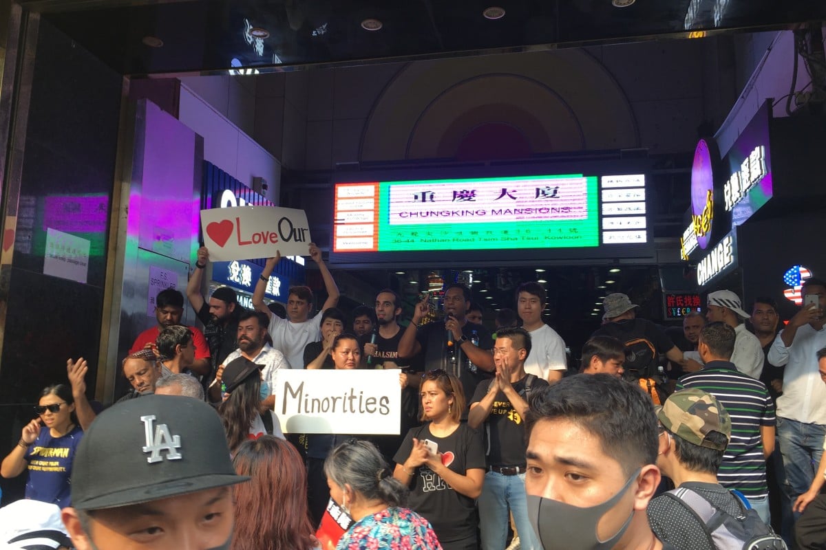 A group of ethnic minorities distributes water to protesters at the entrance of Chungking Mansions.