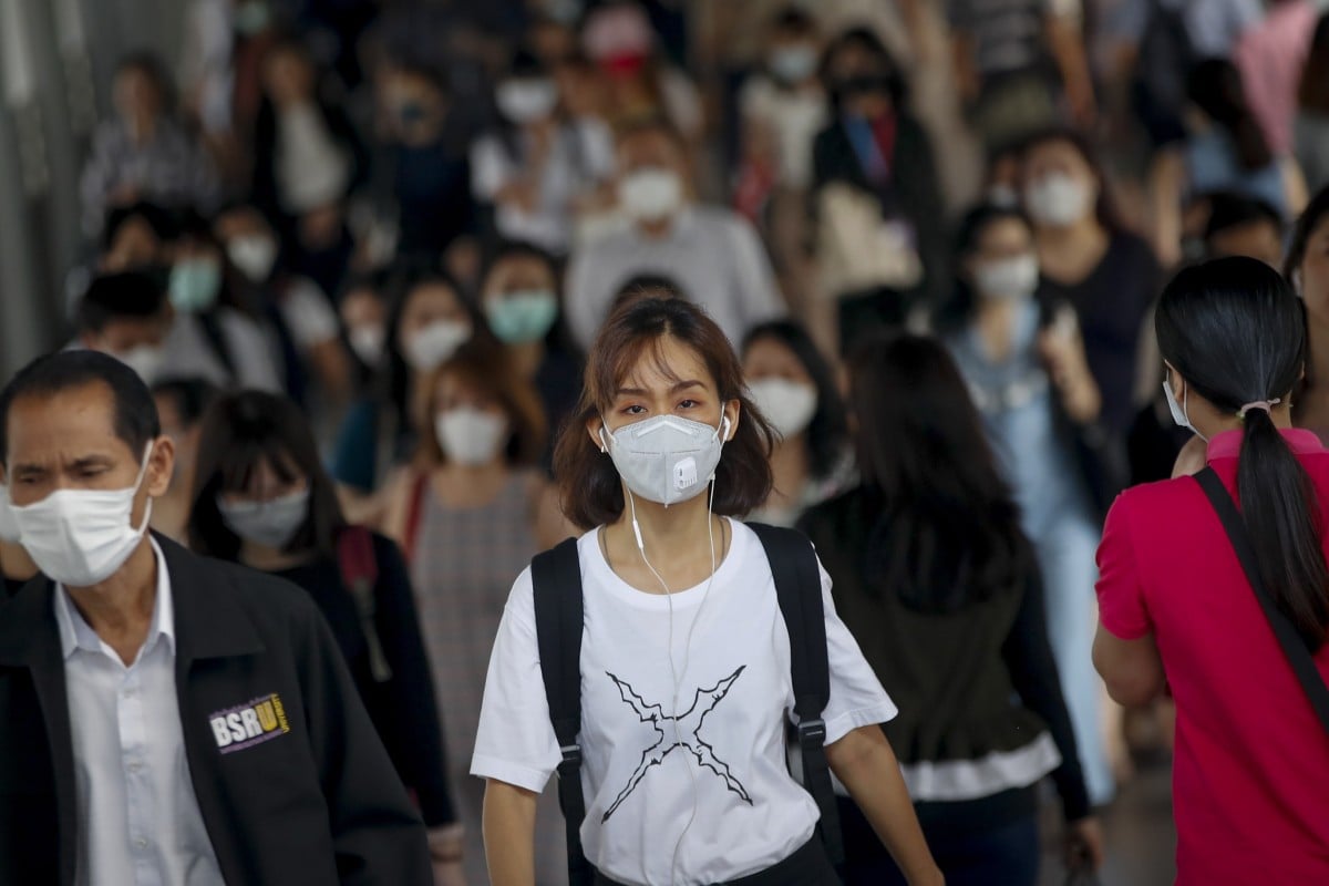 Commuters wearing masks exit the Bangkok Mass Transit System in Thailand’s capital on Thursday.