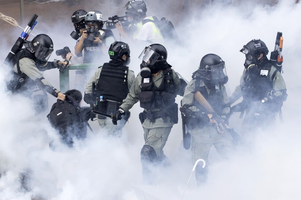 Riot police detain a student activist at Hong Kong Polytechnic University on Monday.