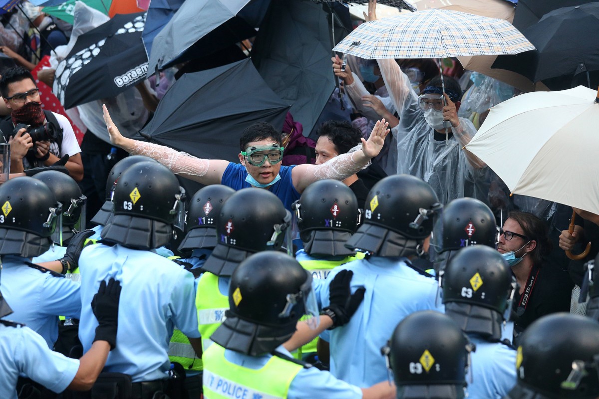 Protesters and police officers on Connaught Road Central in Admiralty.