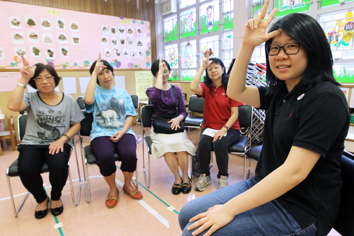 Anita Yu (right) also teaches sign language to the parents of deaf children.