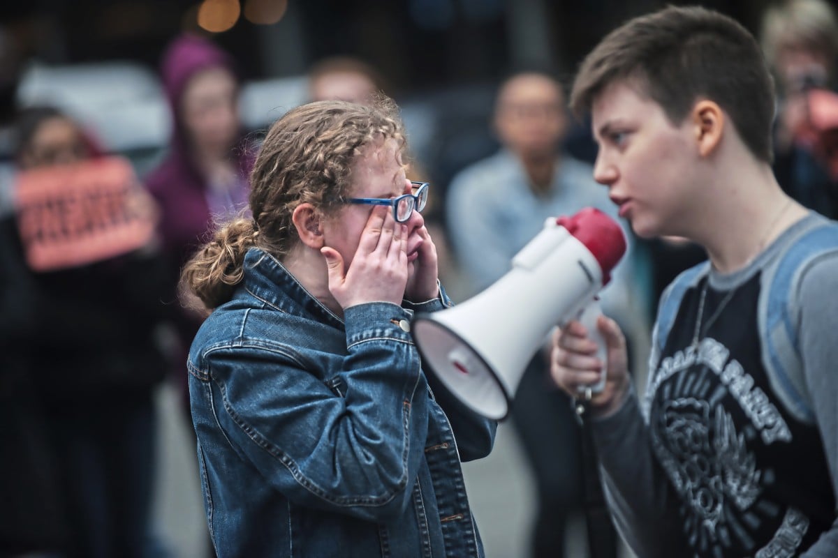 Student Taylor Fraasch wipes her tears as she prepares to speak during a walk-out in solidarity with other high schools across the US to show support for Parkland, Florida students.