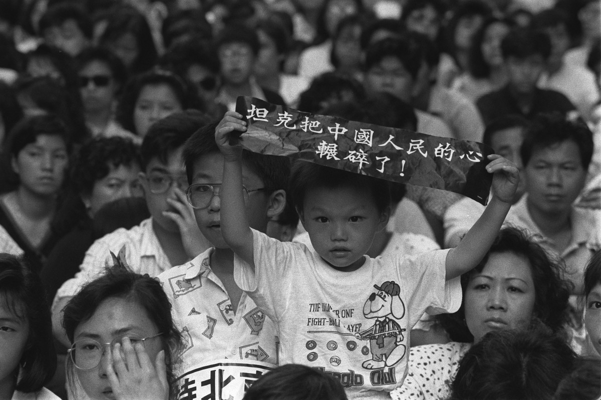 A child holds a placard that reads “tanks crush Chinese people's hearts” during a June 11, 1989, gathering in Hong Kong to remember those killed in the Tiananmen crackdown.