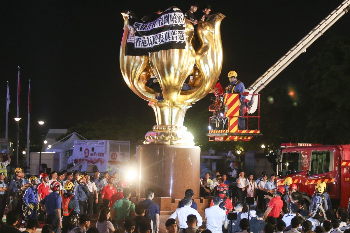 Arrests made after activists protest at the statue in Golden Bauhinia Square.