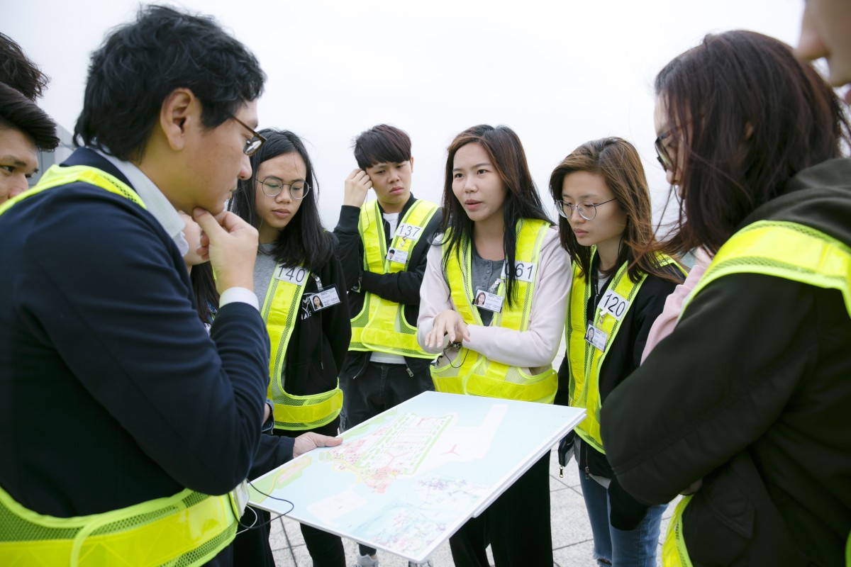 Students learn about the planning behind the three runway system at the Hong Kong International Airport.