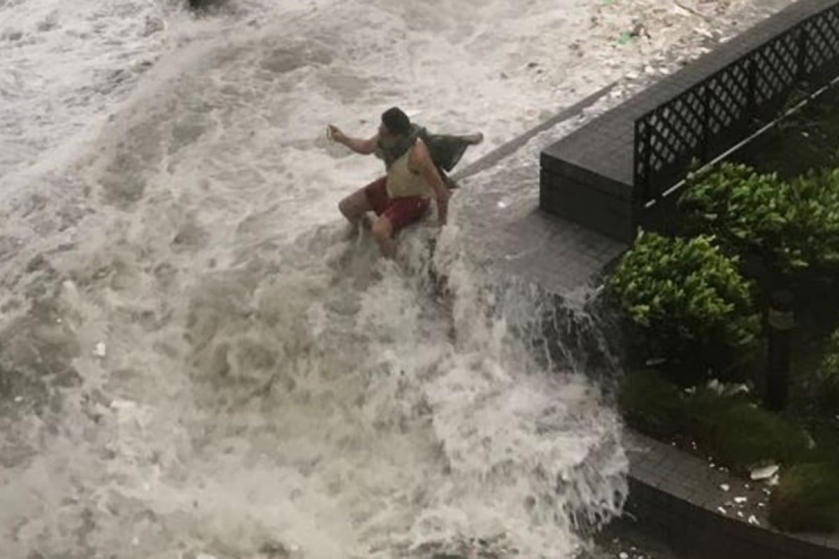 A resident battles the elements in Hong Kong's Eastern District.
