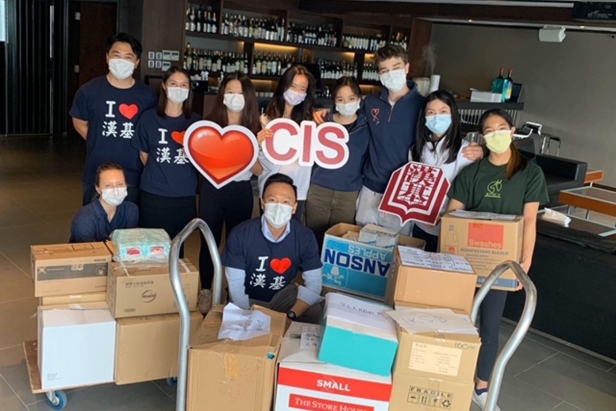 Students and alumni from Chinese International School with boxes full of masks and sanitiser.