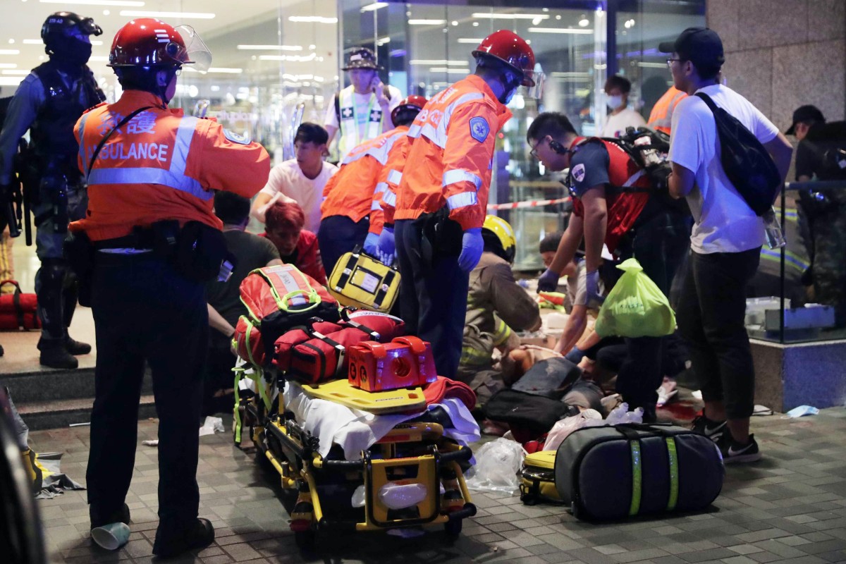 Paramedics attend to the injured outside Cityplaza.