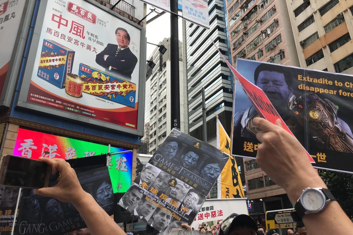 In this photo taken near East Point Road in Causeway Bay, a banner on the right implies that if the proposed extradition bill becomes law, people who are sent to China for trial could disappear forever.