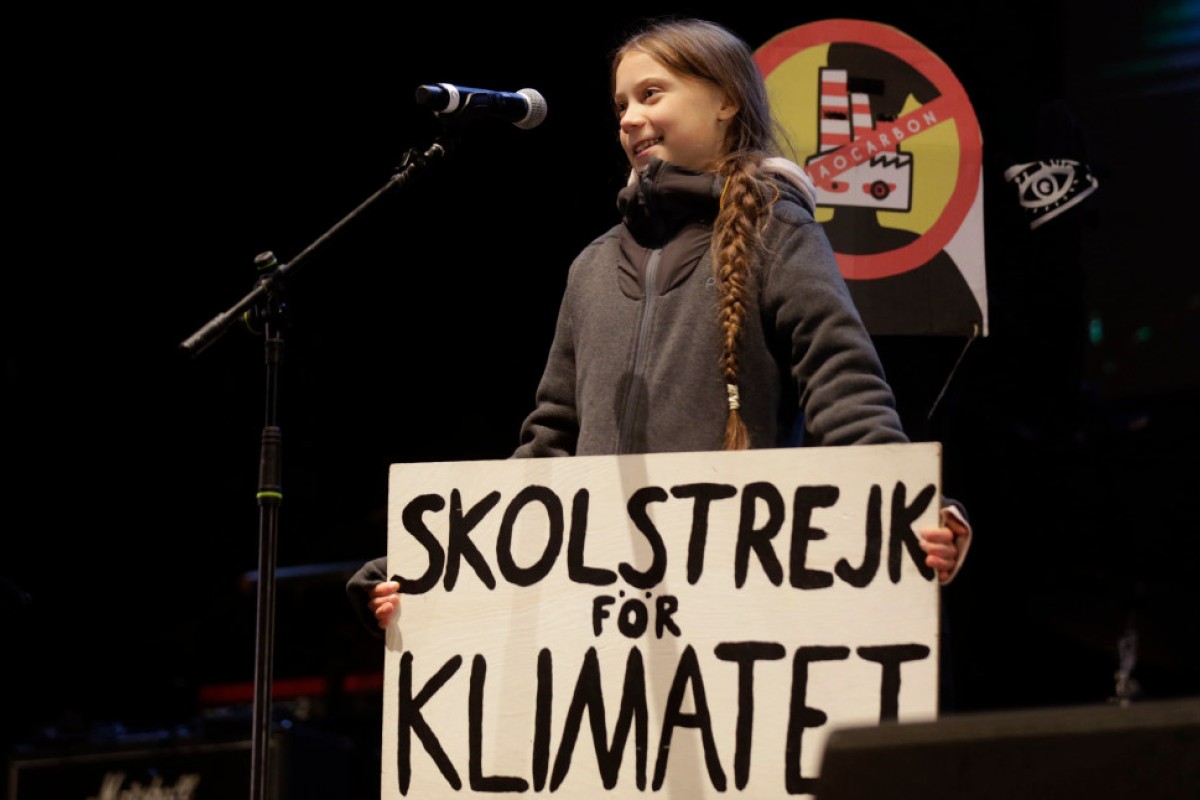 Climate activist Greta Thunberg speaks to assistants during a demonstration in Madrid, Friday Dec. 6, 2019.