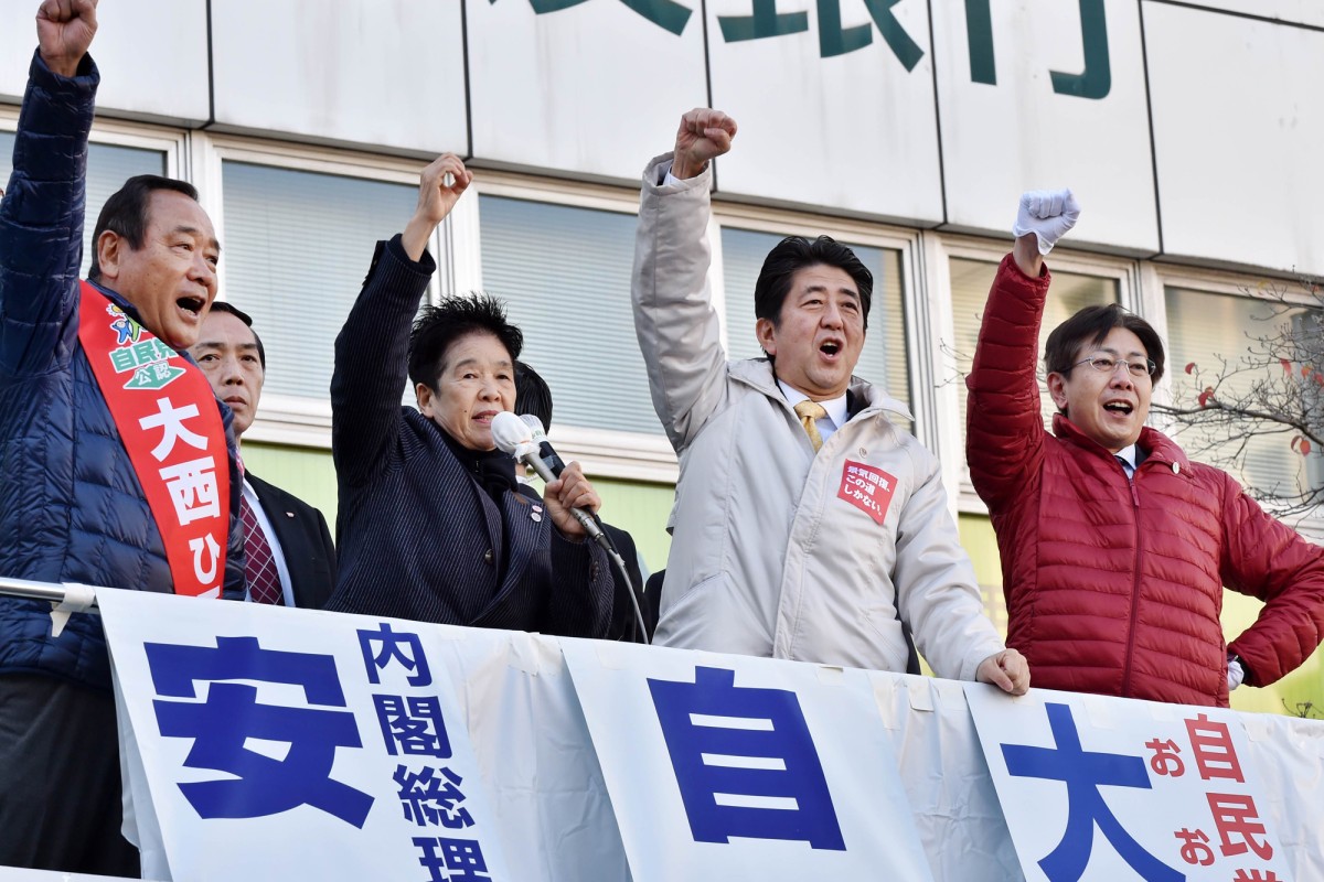 Japanese Prime Minister and ruling Liberal Democratic Party (LDP) leader Shinzo Abe (2nd from right) attends a campaign