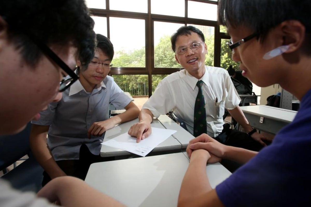 John Tan Kang (with tie), principal of Kowloon Wah Yan College, only got Level Four in his Liberal Studies DSE although he was the one who drafted the syllabus.