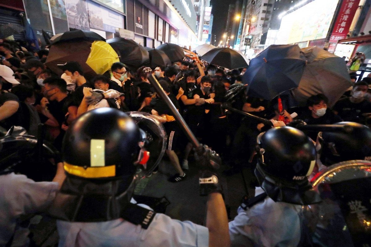 Protesters clash with police officers in Shan Tung Street in Mong Kok on Sunday night.