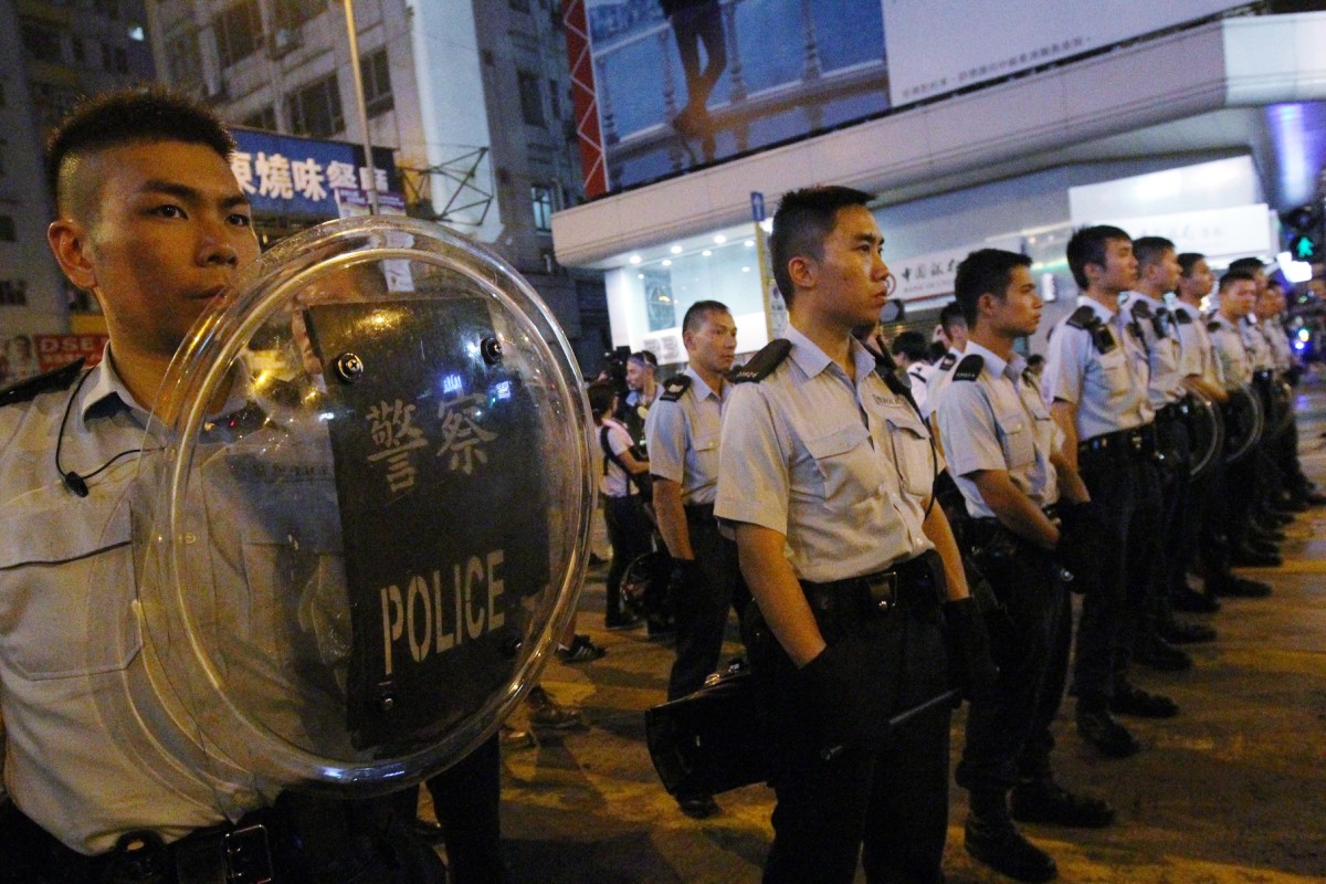Police officers stand guard in Mong Kok