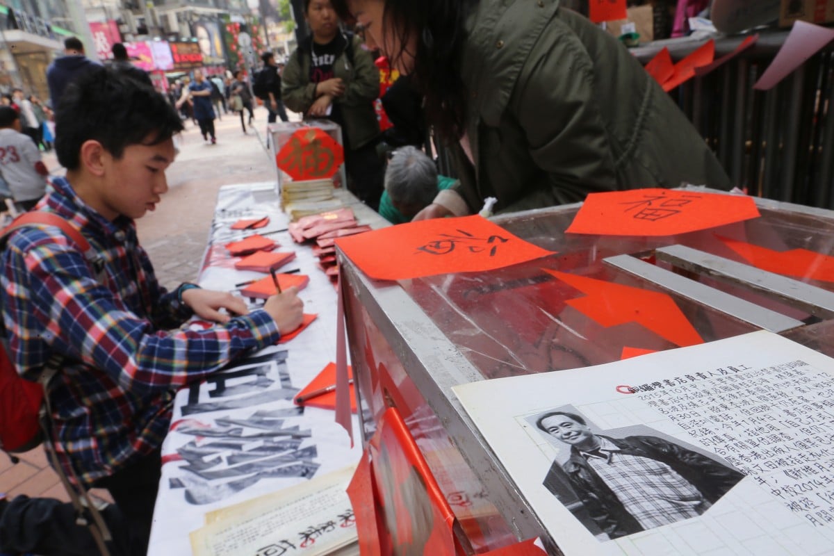 A man writes a greeting card to Lee Bo and other missing persons at Street booth in Causeway Bay.