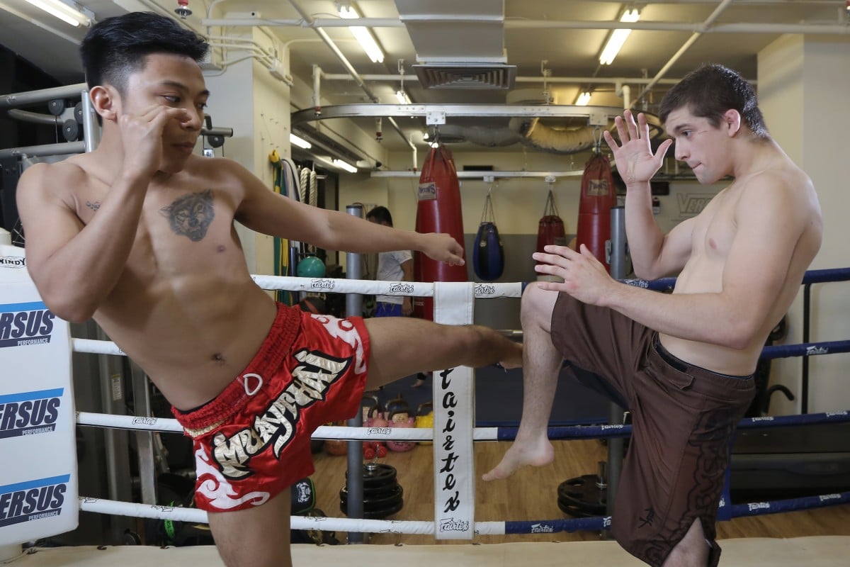 Mike Dacuno (L) and Max Leali practice Muay Thai at Versus Performance.