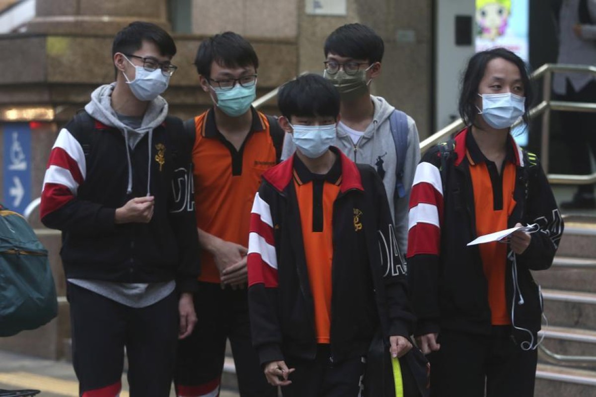 People wearing face masks to protect against the spread of the new coronavirus walk on a street in Taipei, Taiwan.