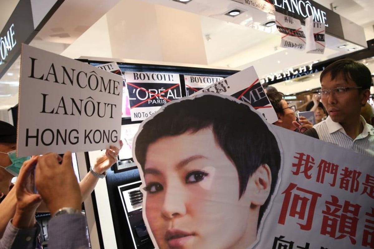 Protesters hold “Boycott Lancome” banners inside Lane Crawford Department Store in Causeway Bay.