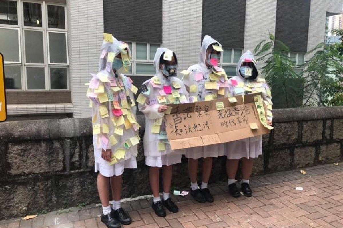 Students from Carrie Lam's alma mater gathered outside school and formed some human Lennon walls this afternoon.