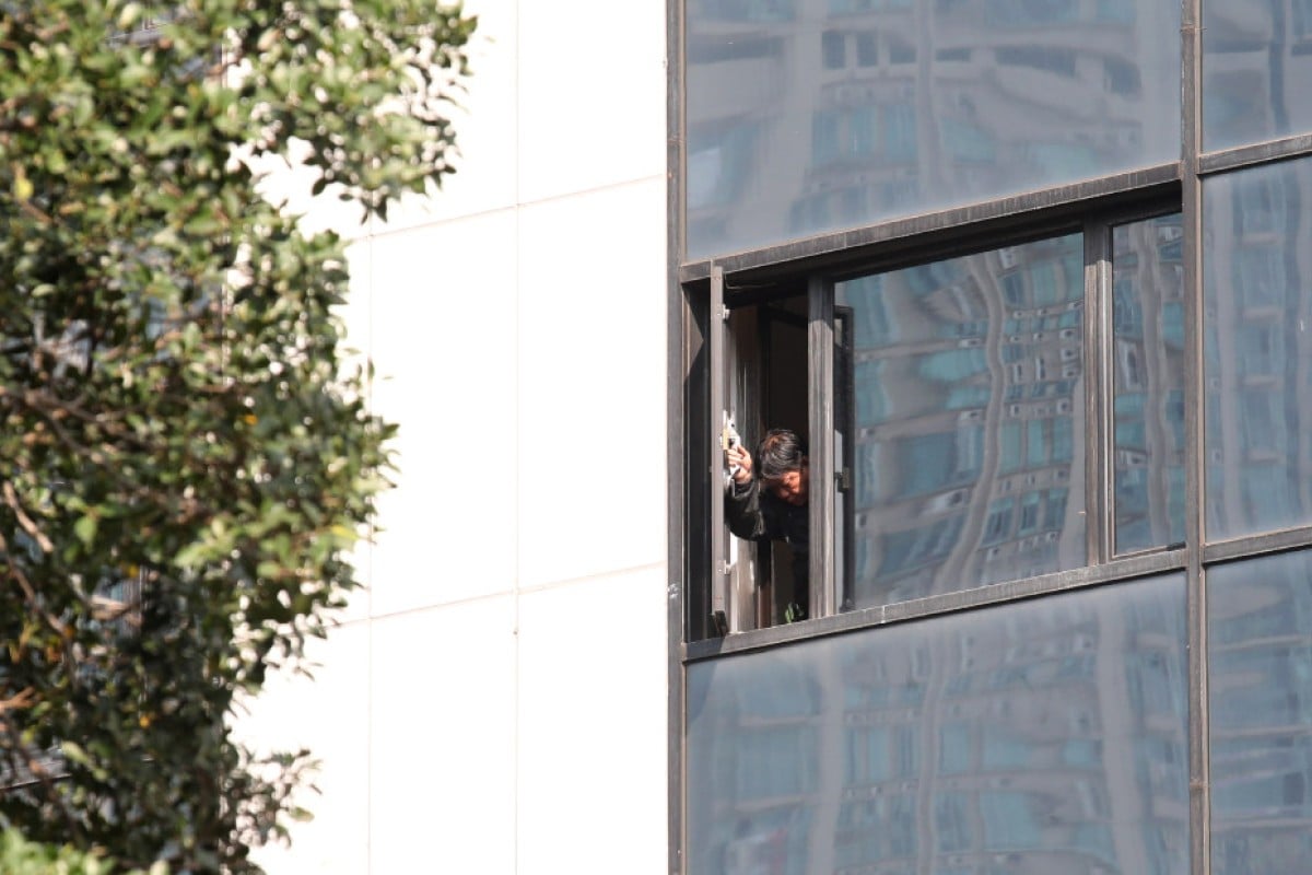 A worker checks a window at the hotel on Tuesday.