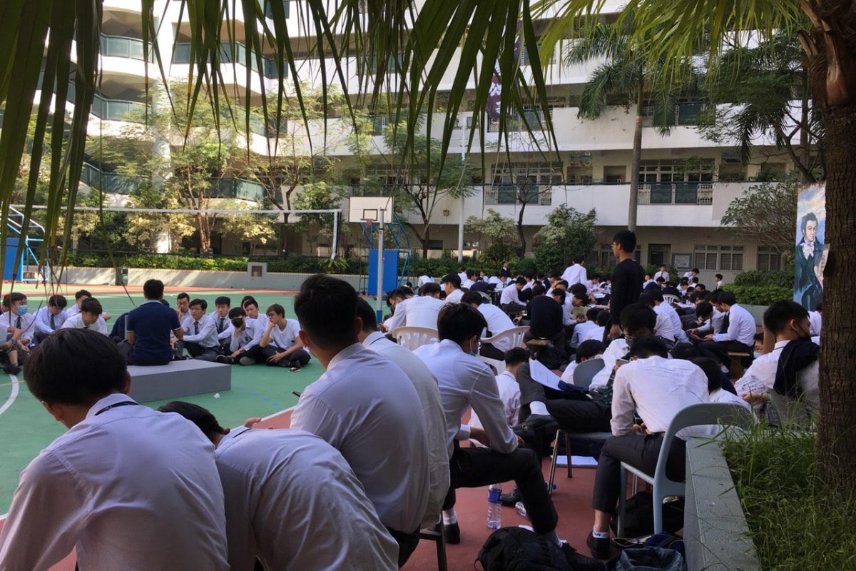 Ying Wa College students are gathered at the school playground to show support for the arrested student.