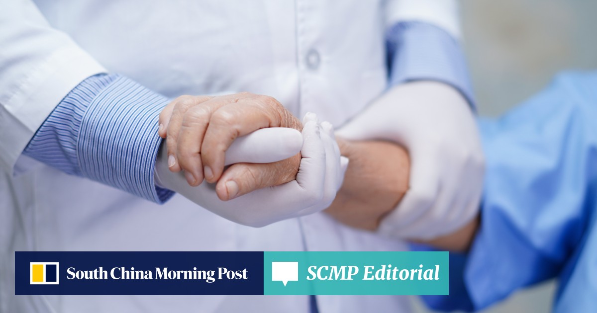 Two healthcare professionals are holding hands in a supportive gesture during a launch event for dual-track pathways in Hong Kong's medical field in 2025.