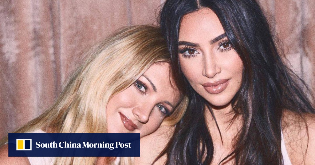 Kim Kardashian poses with her two new best friends for a SKIMS launch