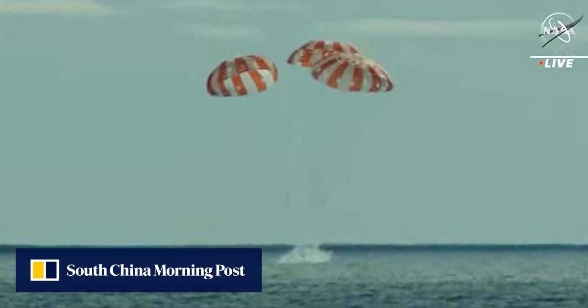Nasa’s Orion capsule blazes home from test flight to moon, splashing down into Pacific