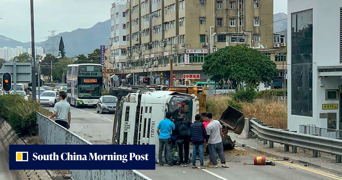 Hong Kong truck driver rescued by passers-by after vehicle hits central barrier and overturns