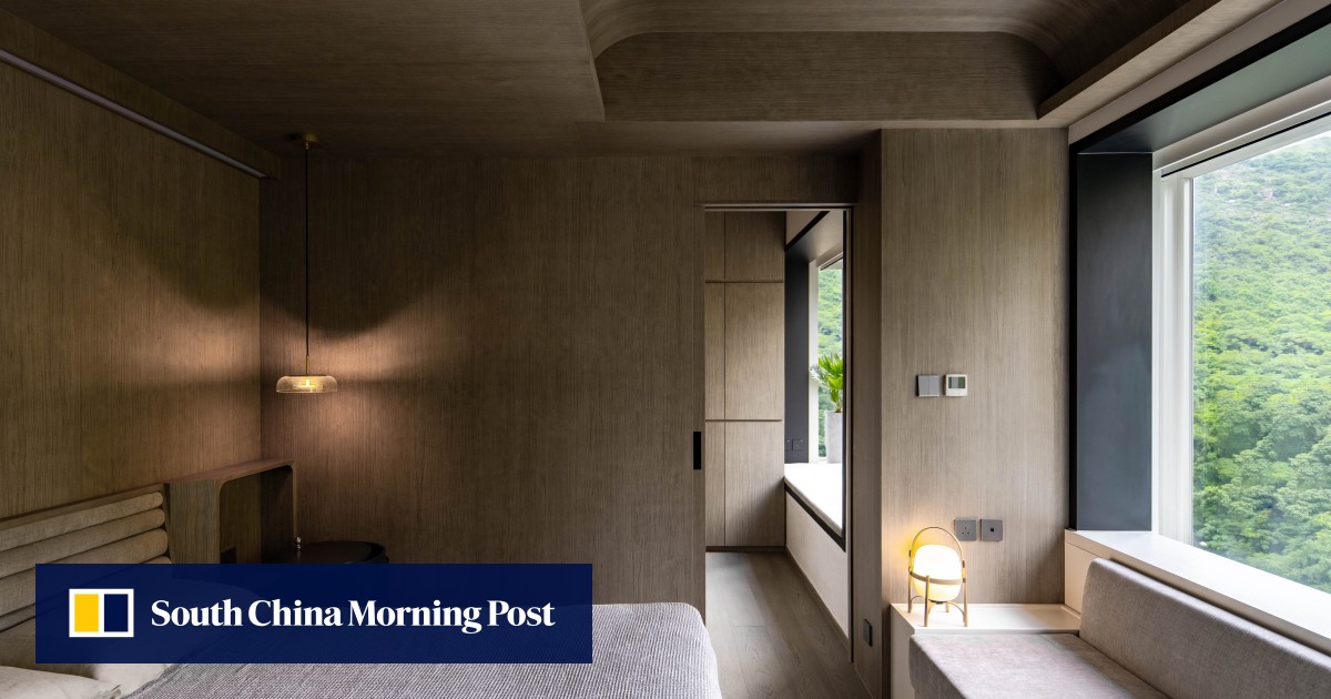 Empty nesters’ home renovation with art deco touches exploits tree setting to create restful interior; natural stone, wood, and green accents tie outside and inside together