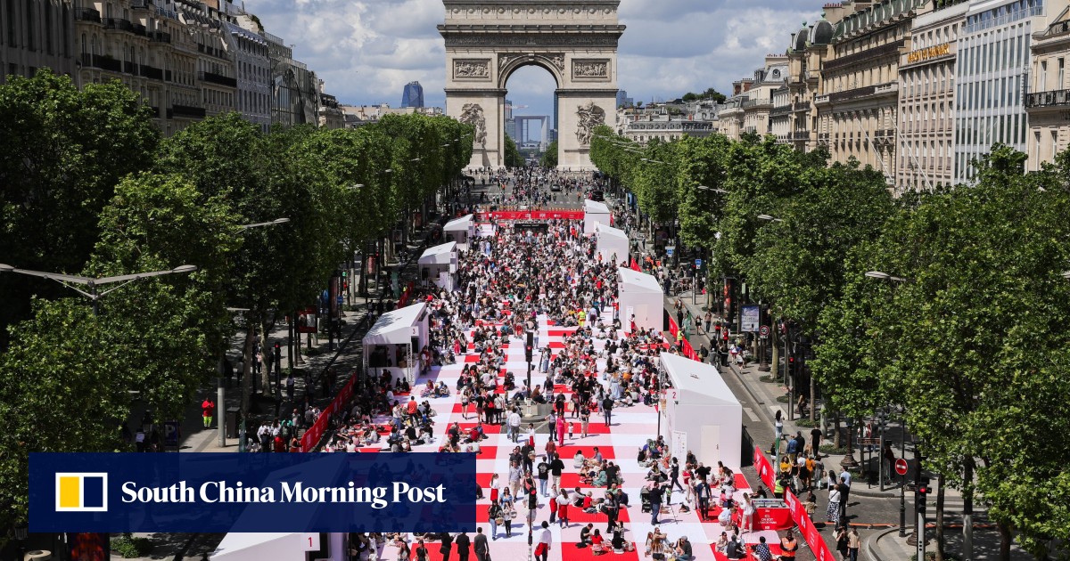 Paris’ traffic-clogged Champs-Elysees turned into a mass picnic blanket for an unusual meal
