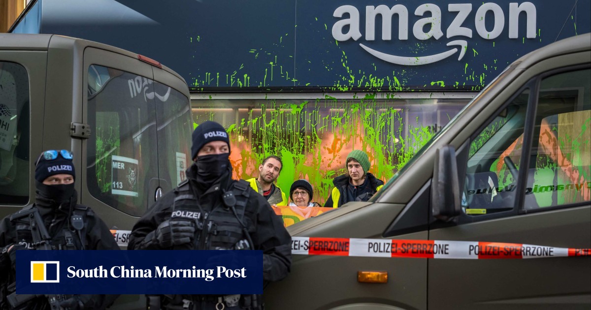 Climate activists at Davos meeting paint Amazon base green, disrupt helicopters