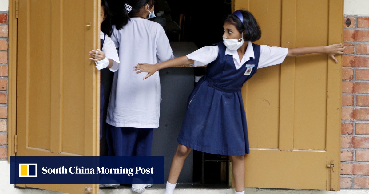Malaysia battles influenza outbreak as schools close before crucial exams