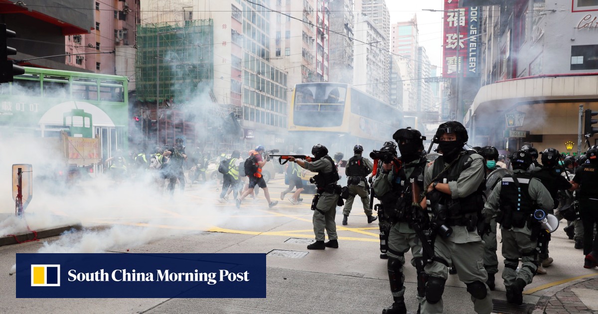Tear gas fired arrests made as thousands protest against Beijing s